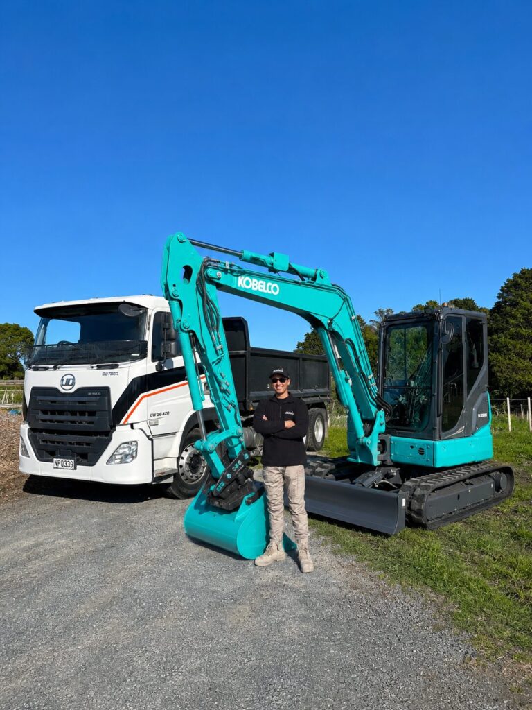Brendan, owner-operator of Peak Earthworks, on site with his digger and tipper